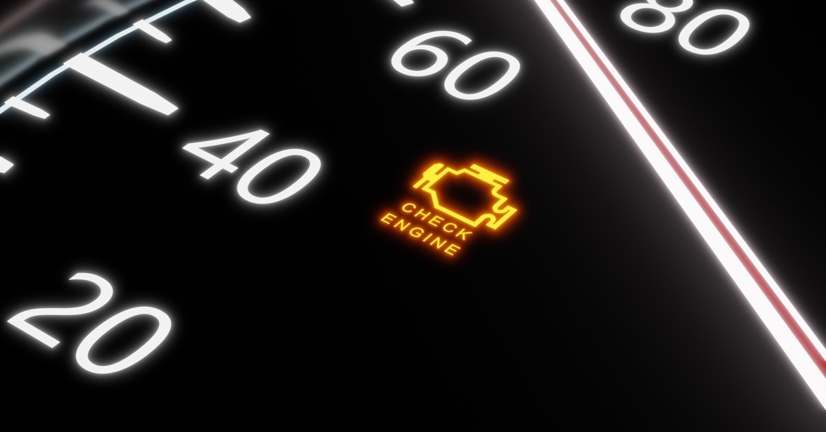 A close-up view a car's dashboard and speedometer. The arrow is pointing at '70' while the check engine light is on.