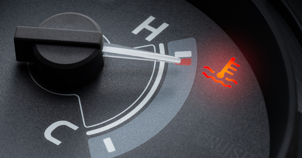 A close-up of an engine temperature gauge on a car's dashboard. The pointer is on the 'h' and the temperature light is on.